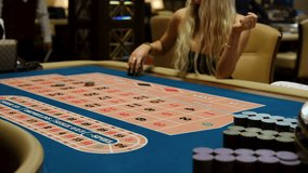 Casino Roulette Table with Dealer Arranging Bets and Chips in Action - Powered by Shutterstock - Get 15% off with code: PIKWIZARD15