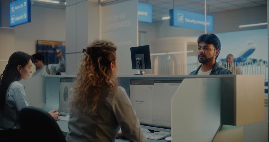 Multiethnic Passengers at Check-in Counter: Female Airline Agents Accepting Documents and Airplane Tickets, Checking Biometric Data on Computers. Passport Control in International Airport Terminal.