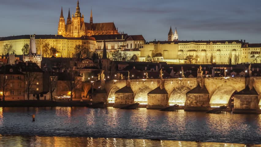 Evening view of Prague Castle and Vltava River illuminated at sunset. Night HDR zoom out shot of Prague city center, Czech Republic 