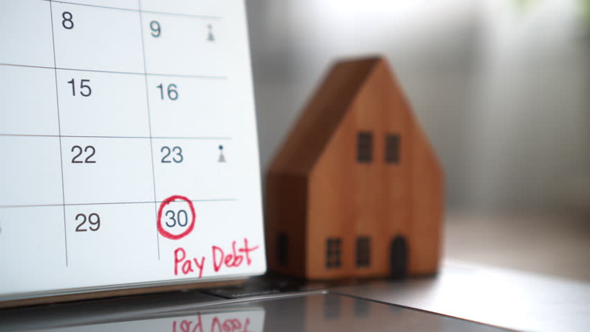 Close-up of a marked due date on the calendar as a reminder to pay monthly debt or mortgage for house or real estate, helping manage finances and avoid missing loan payments