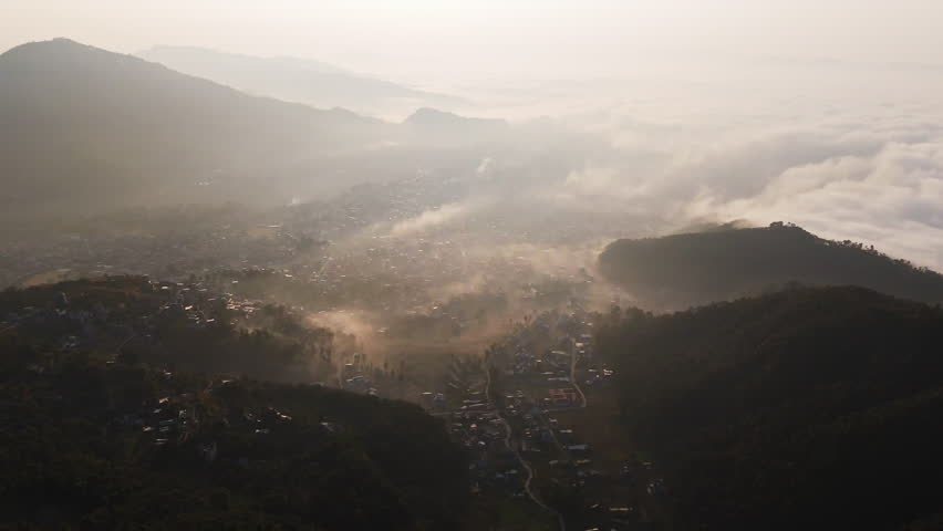 Aerial overview of the mist covered Pokhara city and lake Phewa, sunrise in Nepal
