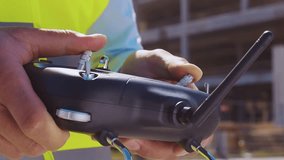 Professional builder standing in front of construction site. Foreman in hardhat helmet and vest. Office building and crane background. Business, real estate and investment. - Powered by Shutterstock - Get 15% off with code: PIKWIZARD15