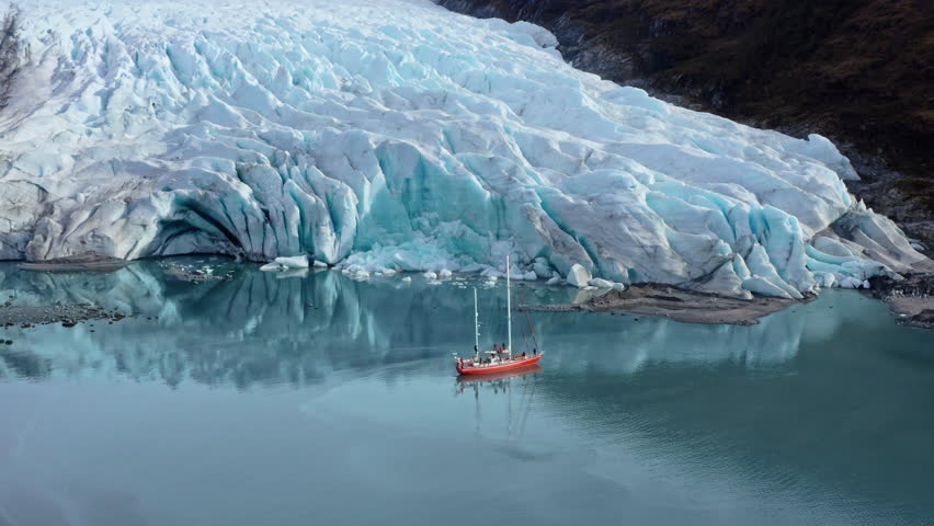 Tourist Boat Exploring Glaciers Along Beagle Channel In Tierra del Fuego, Argentina. Aerial Drone Shot