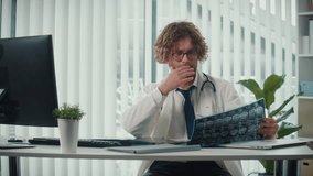 A Doctor Works, Analyzing X-rays and CT Scans on a Computer Screen He Reviews Digital Medical Data to Provide Accurate Diagnoses and Treatment Plans. Concept of Medical Professionalism and Expert Care - Powered by Shutterstock - Get 15% off with code: PIKWIZARD15