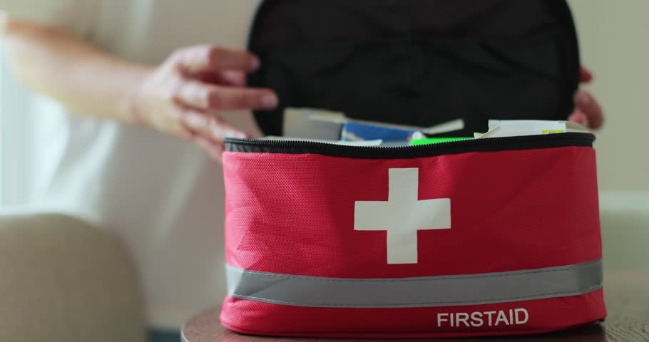 Woman open the first aid kit at home. First aid kit.
