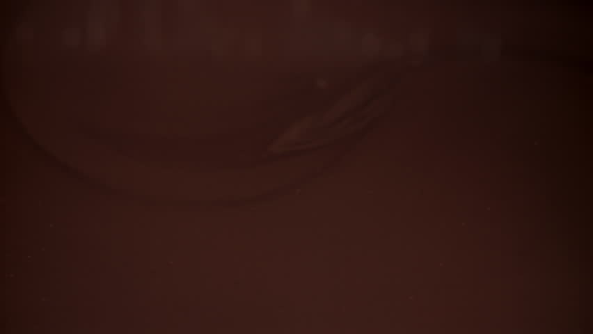 The hazelnuts fall into the liquid chocolate. Filmed on a high-speed camera at 1000 fps. High quality FullHD footage