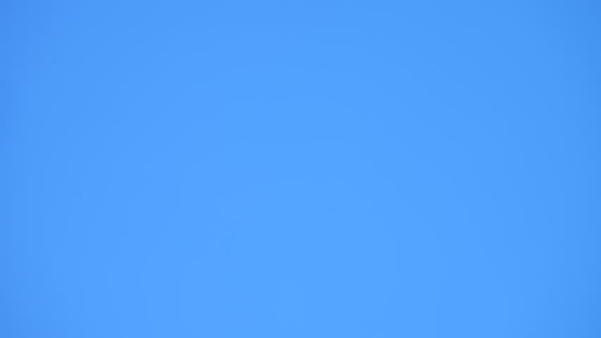 Moon moving across soft blue sky in daylight with visible crater texture. Time lapse tracking lunar path during day for science and astrology. Timelapse moon gliding through sky for astronomy and