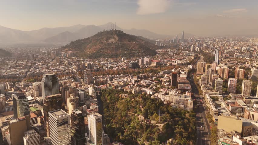 Aerial view of de Chile captured on a bright sunny day, with Parque Metropolitano de visible in background.