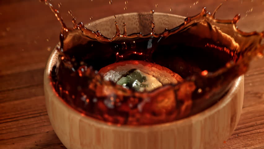 The Japanese roll falls into the soy sauce. Filmed on a high-speed camera at 1000 fps. High quality FullHD footage