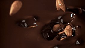 The almonds fall into the melted chocolate. Filmed on a high-speed camera at 1000 fps. High quality FullHD footage - Powered by Shutterstock - Get 15% off with code: PIKWIZARD15
