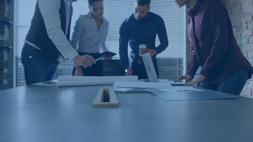 Business professionals collaborating around table reviewing docs with laptop network icons floating. Teamwork, innovation, digital connectivity, brainstorming, modern workspace, corporate strategy, - Powered by Shutterstock - Get 15% off with code: PIKWIZARD15