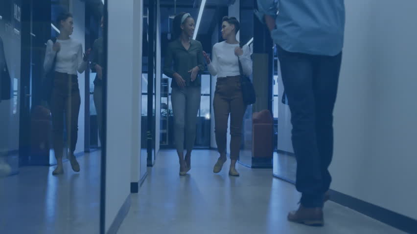 Corporate team walking through office hallway, showcasing digital network connection icons overhead. Collaboration, teamwork, innovation, communication, professionalism, modern, connectivity - Powered by Shutterstock - Get 15% off with code: PIKWIZARD15