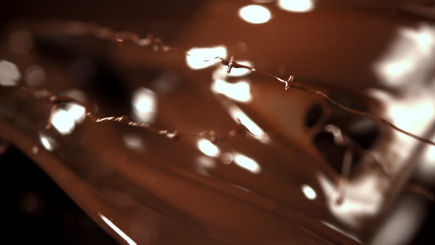 Splashes of melted liquid chocolate. Filmed on a high-speed camera at 1000 fps. High quality FullHD footage