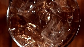 Ice falls into a glass of whiskey. Filmed on a high-speed camera at 1000 fps. High quality FullHD footage - Powered by Shutterstock - Get 15% off with code: PIKWIZARD15