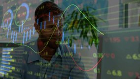 financial analyst sitting at desk in modern office, viewing laptop with stock market data overlays. Business, finance, analytics, technology, innovation, corporate, professional - Powered by Shutterstock - Get 15% off with code: PIKWIZARD15