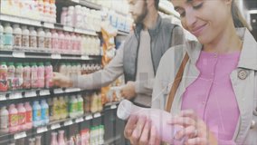 Couple browsing refrigerated beverage shelves in supermarket aisle, with floating price tags. Grocery, retail, consumerism, modern, vibrant, lifestyle, health - Powered by Shutterstock - Get 15% off with code: PIKWIZARD15