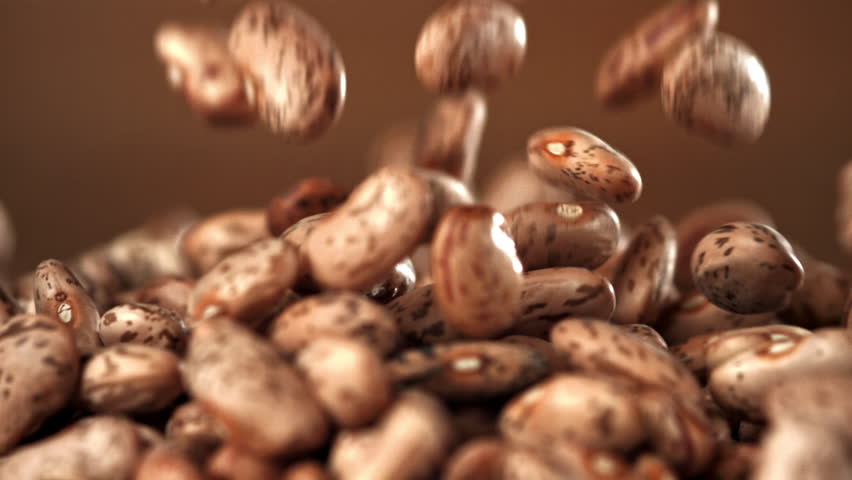 White beans fall on a wooden table. Filmed on a high-speed camera at 1000 fps. High quality FullHD footage