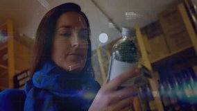 woman examining bottled drink in retail aisle, displaying finance charts and code overlays. Retail, consumer, digital, futuristic, technology, shopping, analysis - Powered by Shutterstock - Get 15% off with code: PIKWIZARD15