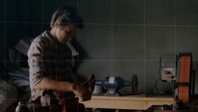 Man adjusting tool in technology workshop, overlaying digital grid map and fluctuating line graphs. Craftsman, workshop, industrial, precision, engineering, innovation, workspace - Powered by Shutterstock - Get 15% off with code: PIKWIZARD15