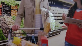 couple exploring produce aisle, tracking market data with floating ticker symbols and line graphs. Fresh produce, digital technology, healthy lifestyle, retail environment, financial graph, consumer - Powered by Shutterstock - Get 15% off with code: PIKWIZARD15