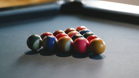 Billiard balls are meticulously arranged in triangular formation on a pool table lit by warm sunlight, signaling the start of a friendly game among friends. - Powered by Shutterstock - Get 15% off with code: PIKWIZARD15