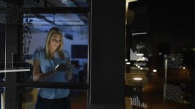 Business analyst reviewing data on tablet in dimly lit office at night, with animated HUD graphs. Technology, data, analytics, visualization, professional, corporate, futuristic - Powered by Shutterstock - Get 15% off with code: PIKWIZARD15