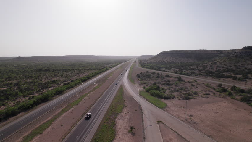 Cars and Trucks drive on I-10 in the West Texas desert