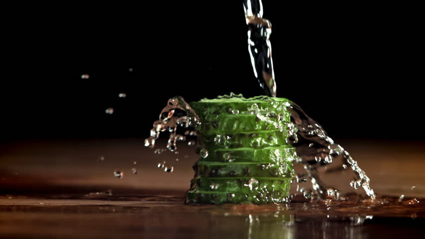 Water is poured over the sliced cucumbers. Filmed on a high-speed camera at 1000 fps. High quality FullHD footage