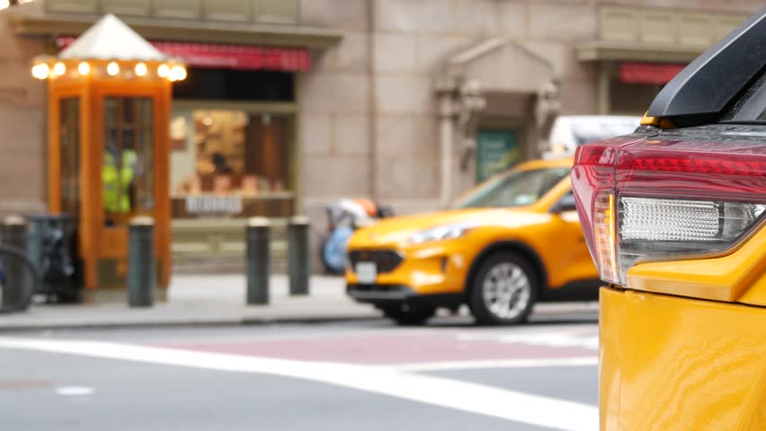 New York City Grand Central Terminal railway station, 42 street. Manhattan Midtown. Yellow taxi cabs, car transport on Pershing Square, NYC USA. American urban road traffic, people,telephone box kiosk
