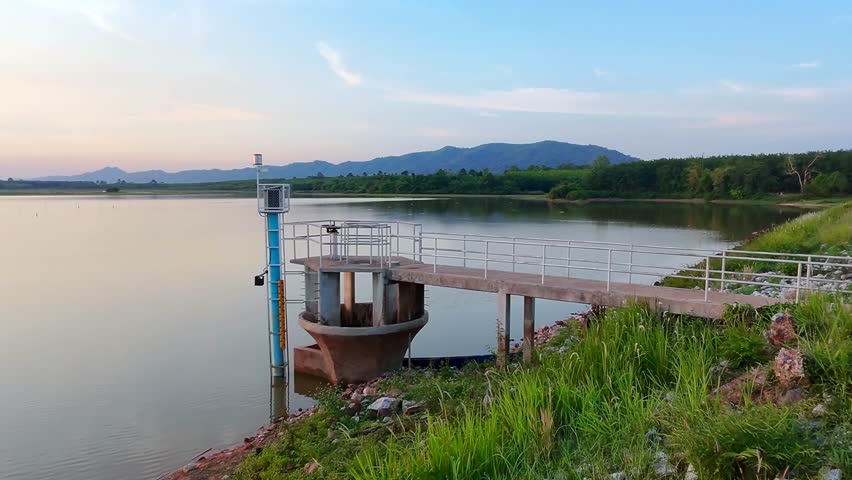 Spillway at a reservoir, a dam and its spillway at a reservoir. Observe the controlled release of water, Witness the raw power of controlled water, Demonstrates water management and engineering