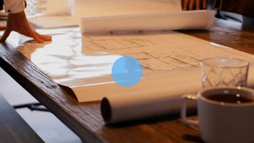 Two male colleagues examining architecture blueprints around table with coffee mugs, network icons. Collaboration, teamwork, urban design, modern office, digital connectivity, professional meeting, - Powered by Shutterstock - Get 15% off with code: PIKWIZARD15