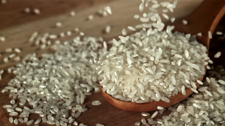 Rice falls into a wooden spoon. Filmed on a high-speed camera at 1000 fps. High quality FullHD footage
