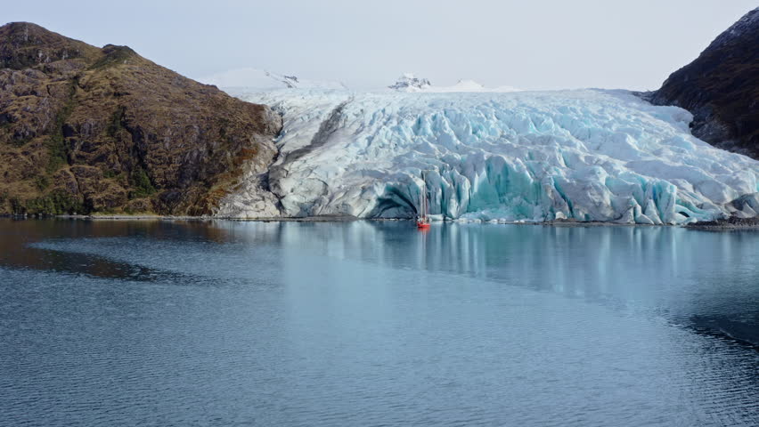 Dramatic Scenery Of Mountains With Ice Formations Through Beagle Channel In Argentina. Aerial Drone Shot