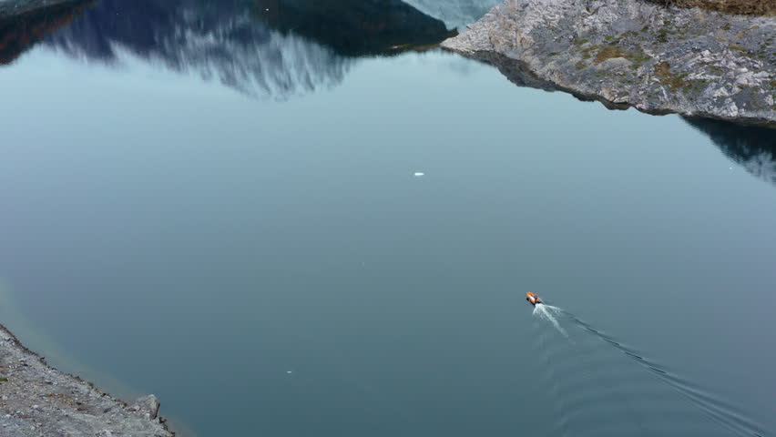 Boat Across Tranquil Waters Of Beagle Channel In Tierra del Fuego Archipelago, Argentina. Aerial Drone Shot