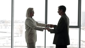 Elderly couple enjoying a cheerful dance by the window, showcasing their love and active lifestyle during winter - Powered by Shutterstock - Get 15% off with code: PIKWIZARD15