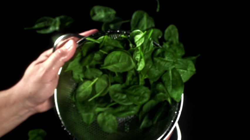 The chef tosses spinach in a saucepan. Filmed on a high-speed camera at 1000 fps. High quality FullHD footage