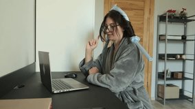 Frustrated woman in bathrobe and heatless hair curlers arguing during video call while gesturing emotionally at laptop screen. Housewife expressing emotions on video chat. Online meeting with friend - Powered by Shutterstock - Get 15% off with code: PIKWIZARD15