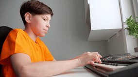 Focused teenager boy plays piano practicing for music class. Thoughtful schoolboy learns to play new melody to perform at school concert - Powered by Shutterstock - Get 15% off with code: PIKWIZARD15