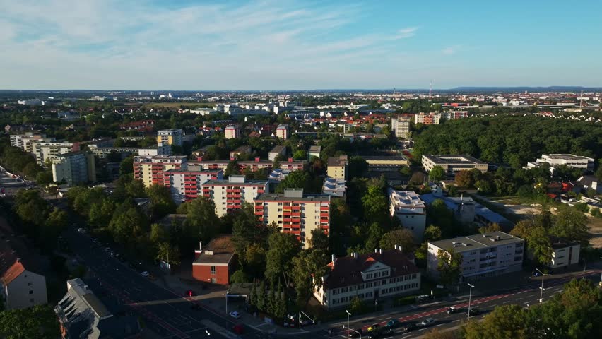 Aerial drone view of Röthenbach Ost in Nuremberg-West, Germany, featuring mid-rise apartment blocks, tree-lined streets and a mix of urban and green residential planning.