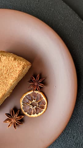 A slice of honey puff cake or pumpkin, carrot and cream pie, vegan sweets for the dinner table