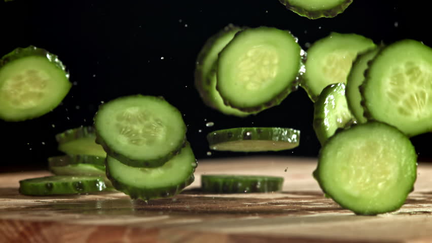 Sliced cucumbers fall on the table. Filmed on a high-speed camera at 1000 fps. High quality FullHD footage