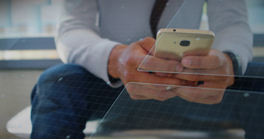 Man tapping gold smartphone in business lounge, viewing translucent blue HUD charts and map. Technological, innovation, communication, professional, sleek, digital, connectivity