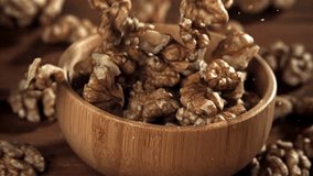 Walnuts fall into a wooden bowl. Filmed on a high-speed camera at 1000 fps. High quality FullHD footage - Powered by Shutterstock - Get 15% off with code: PIKWIZARD15