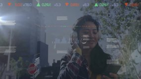 Woman wearing headphones walking city street, checking smartphone with floating finance charts. Technology, urban, futuristic, data visualization, commuting, innovation, lifestyle - Powered by Shutterstock - Get 15% off with code: PIKWIZARD15