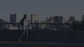 Woman walking rooftop terrace overlooking city in finance, with floating stock charts and data. Urban, professional, modern, skyline, forecasting, analytics, business - Powered by Shutterstock - Get 15% off with code: PIKWIZARD15