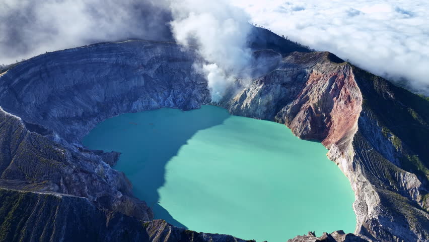Aerial view of Kawah Ijen volcano with turquoise sulfur water lake at sunrise.Amazing nature landscape view at East Java, Indonesia. Natural landscape background,High quality video ProRes