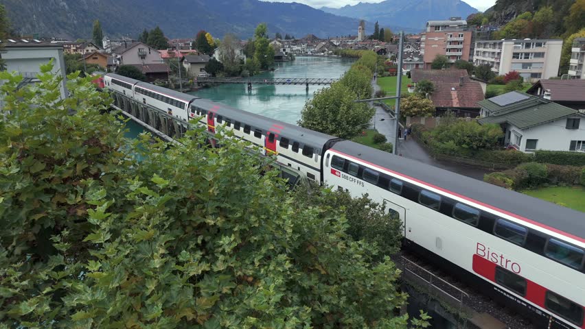 An aerial shot of Luzern Interlaken Express over beautiful Lake Interlaken in Switzerland
