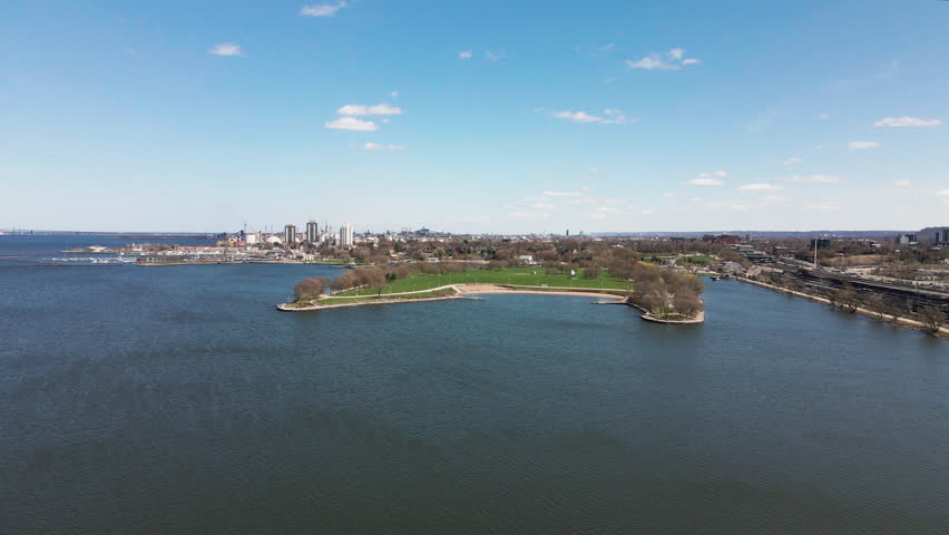 Approaching Bayfront Park On Burlington Bay In Hamilton, Ontario, Canada. Cityscape And Marina In Background. wide drone shot