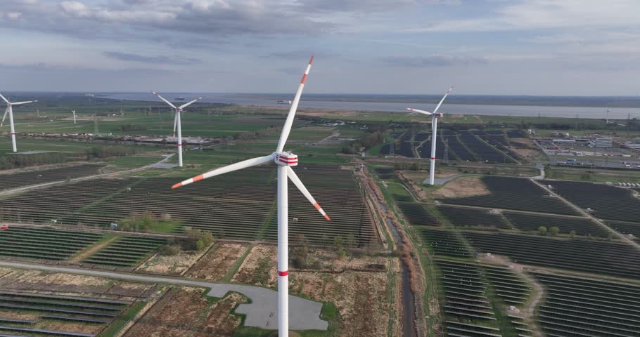 clean renewabale energy in Germany, Brunsbuttel, wind turbines and solar panels in industrial zone. Along the Elbe river.