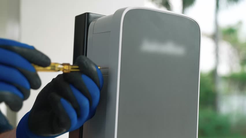 Qualified technician install home EV charging station, providing maintenance service for electric vehicle's battery charging platform at home. EV car technology for residential utilization. Fastidious